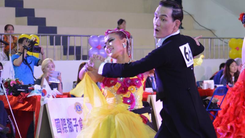 a Para dance couple perform a move