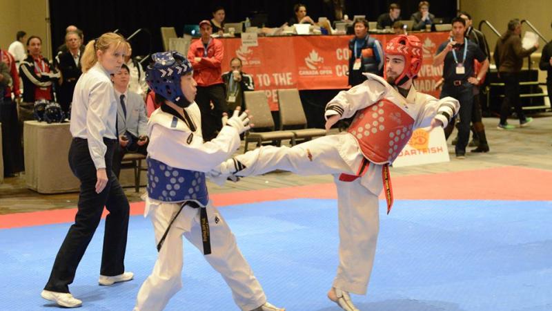 two Para taekwondo fighters on the mat
