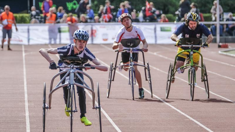 three RaceRunning athletes run down the track