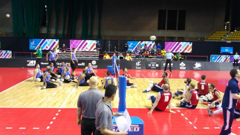 two sitting volleyball teams on the court ready to begin play