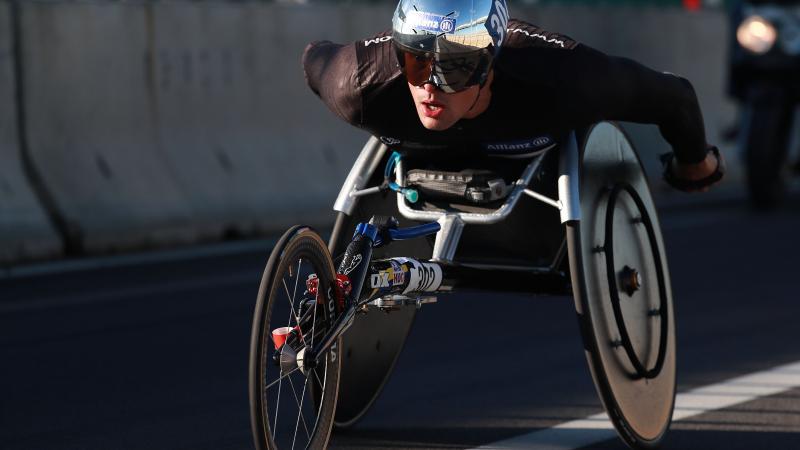 a male wheelchair racer on the road