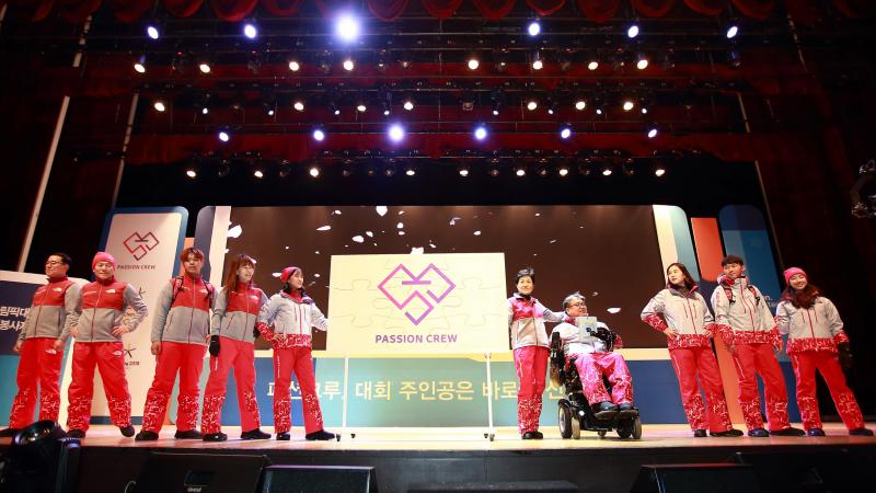 a group of people model outfits on a stage