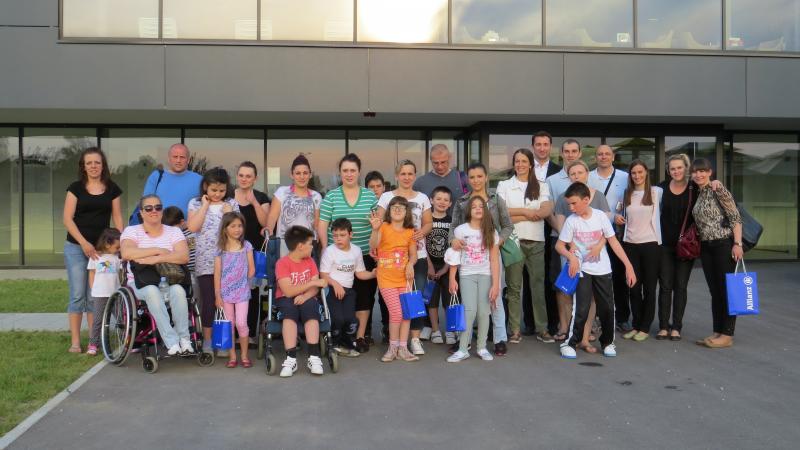 a group of adults and children smile for the camera