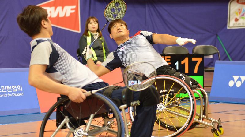 two male Para badminton players on the court