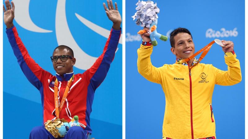 two male Para swimmer raise their arms on the podium