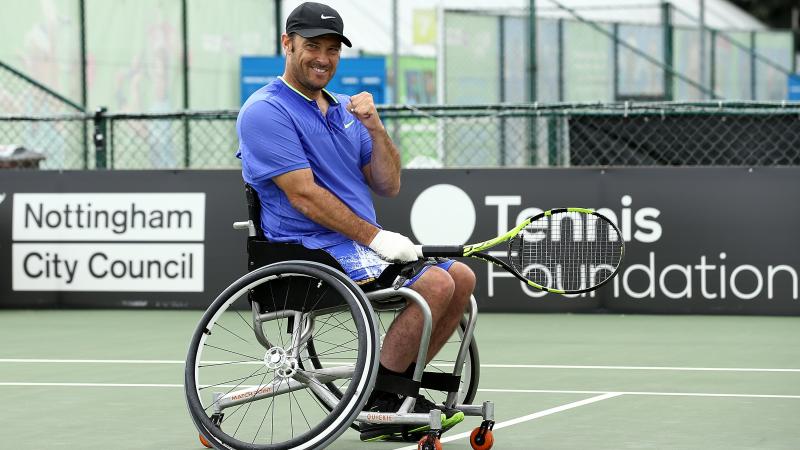 a male wheelchair tennis player gives a fist pump