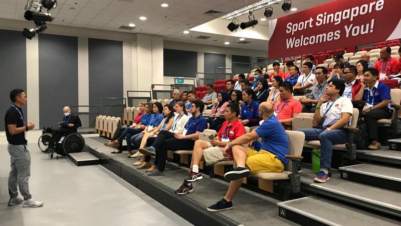 Educator delivers course to audience of coaches and classifiers