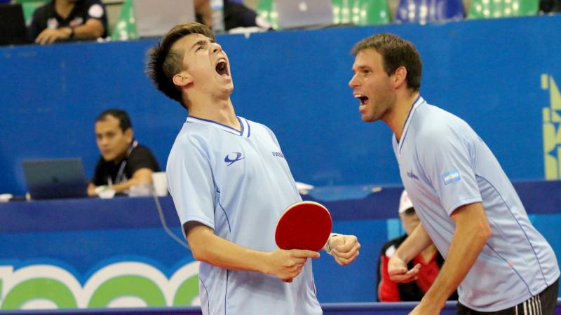 male Para table tennis players celebrate a point