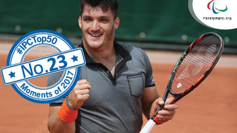 a male wheelchair tennis player celebrates winning a point