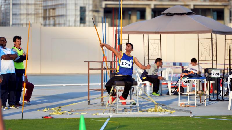 a male Para athlete throws a javelin