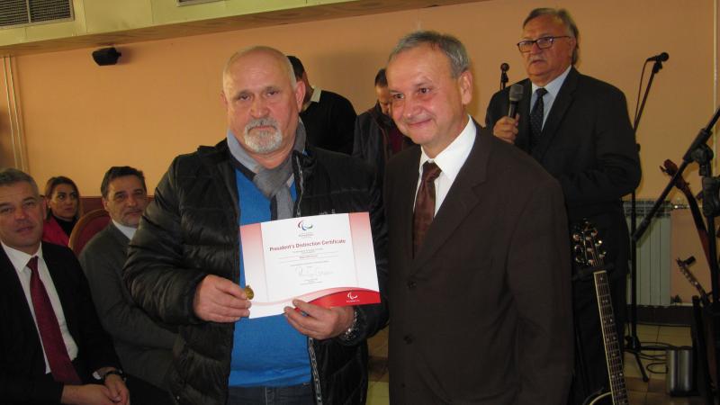 Two men holding up a certificate