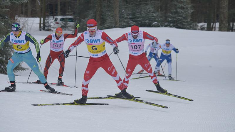 Two vision impaired cross-country skiers race with their guides