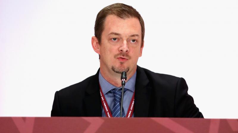 a man speaking at a desk