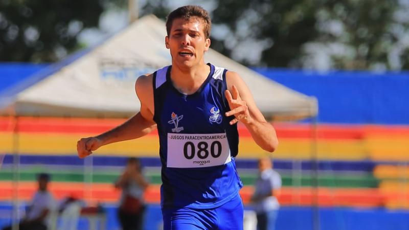 a male Para athlete crosses the finish line