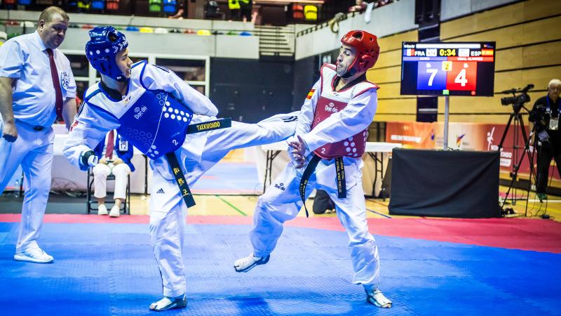 Two male taekwondo athletes fight