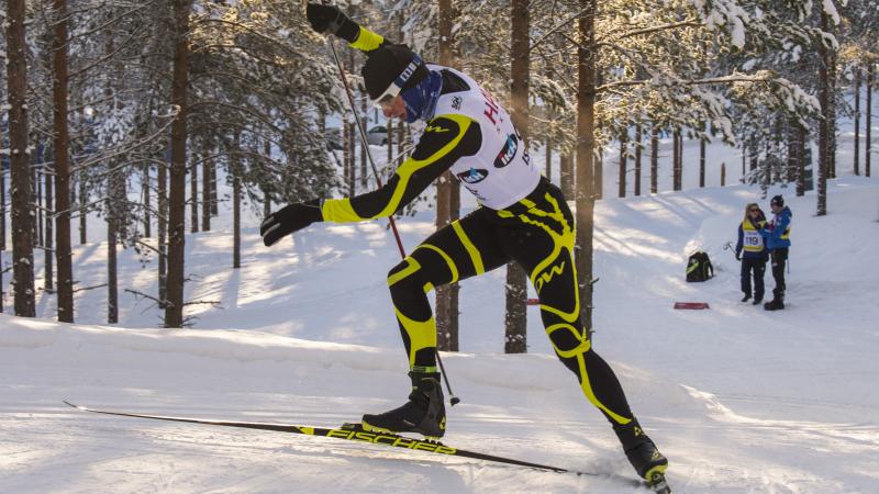 Male standing biathlete racing