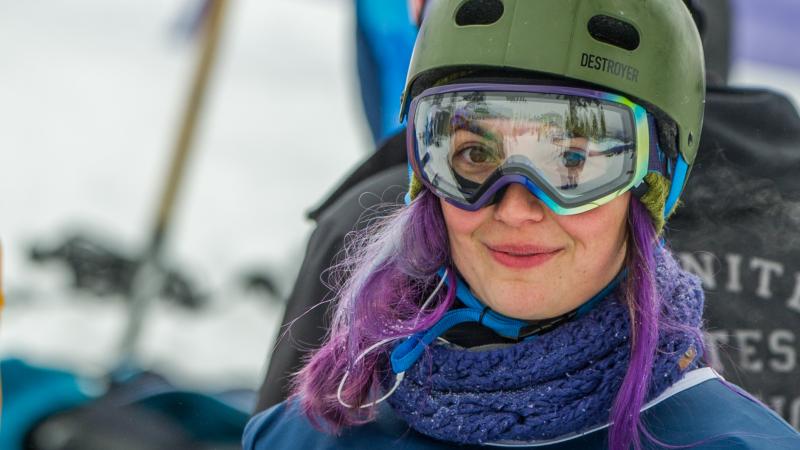 a female Para snowboarder smiles