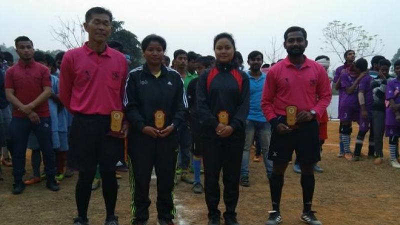 two male and two female referees stand side by side