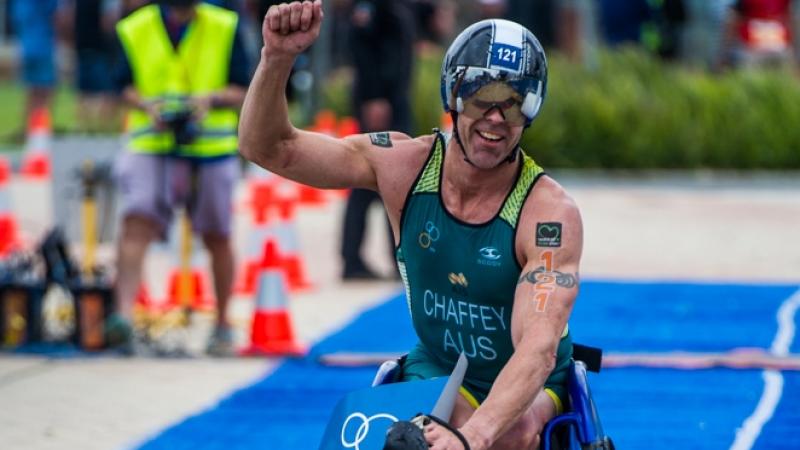 Triathlete celebrates crossing finishing line