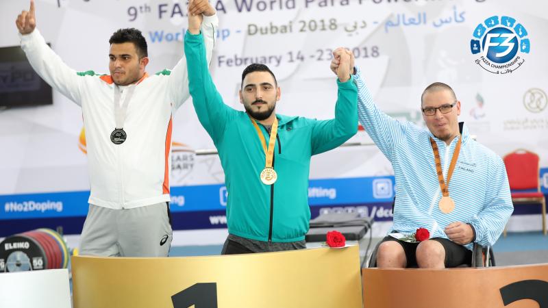 three male powerlifters on the podium