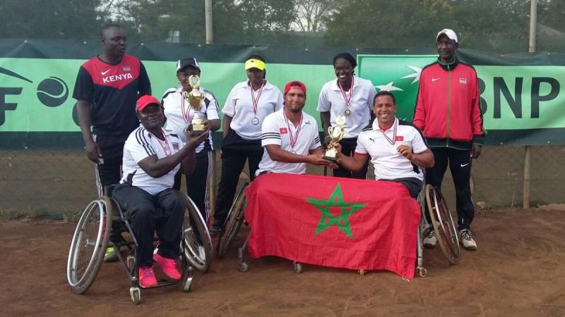 a group of wheelchair tennis players with their trophies