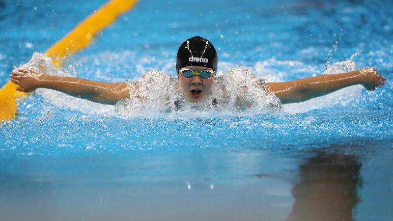 Liesette Bruinsma a female Para swimmer mid-butterfly stroke
