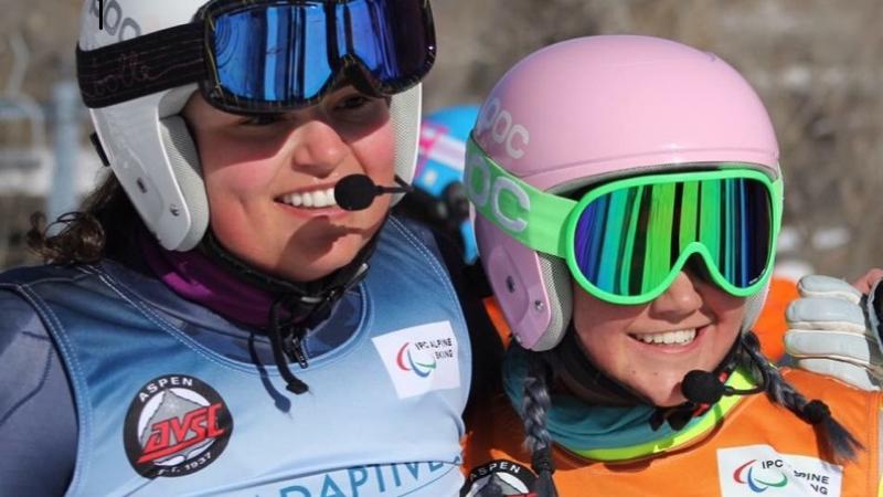 a female vision impaired skier and her guide