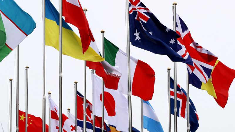 flags from many countries flying in the wind at the Paralympic Village