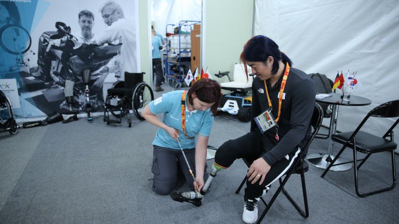 a woman works at repairing a prosthetic leg