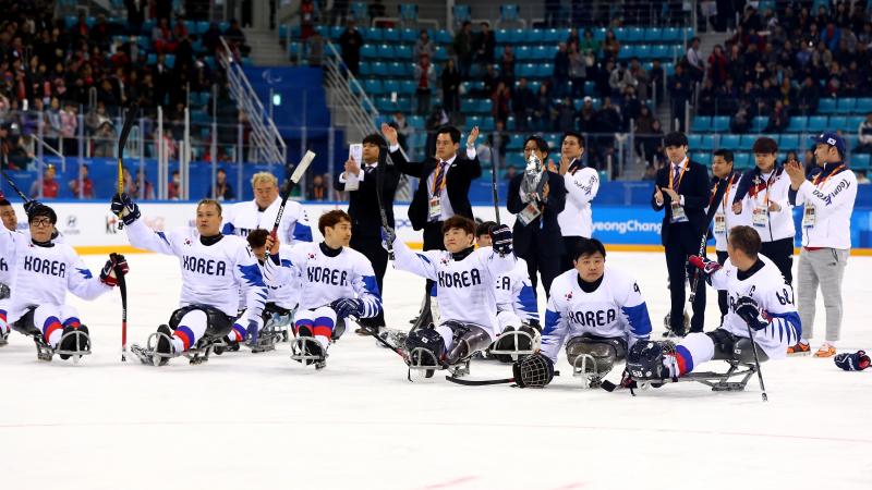 a group of Para ice hockey players on the ice