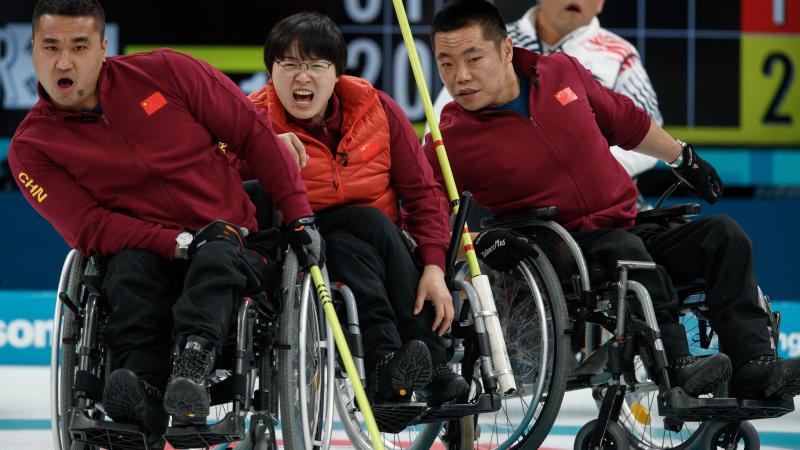 wheelchair curlers watching a stone