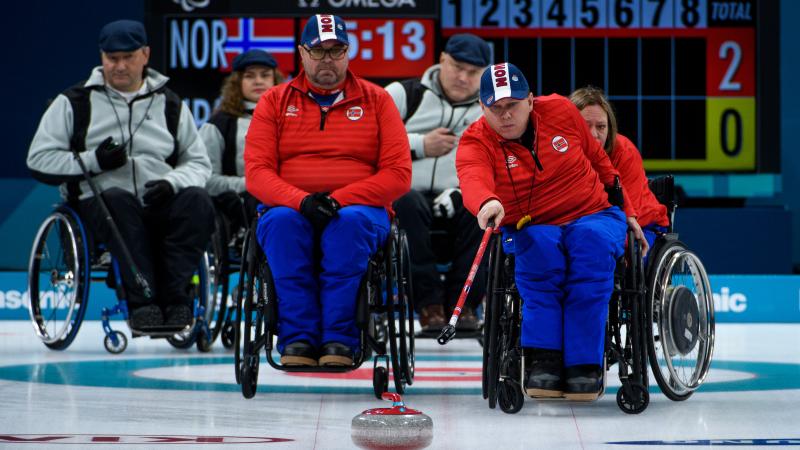 a wheelchair curler plays a stone