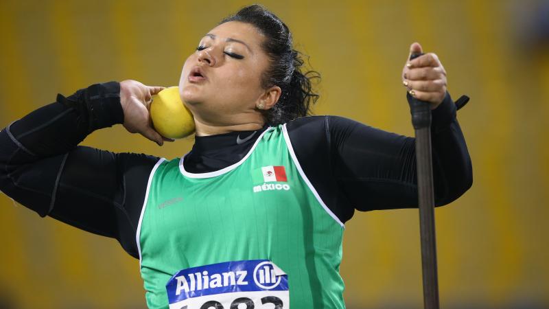 a female shot putter prepares to throw