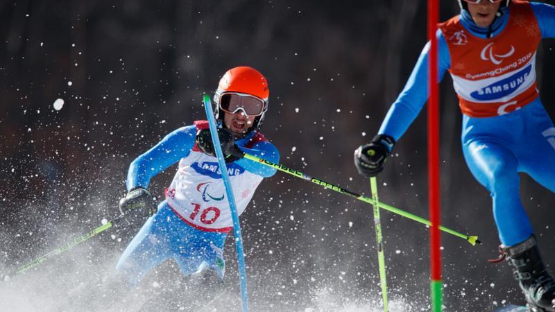 Skiier guide in front of blind skiier