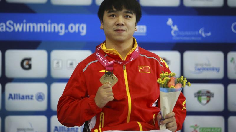 a male Para swimmer on the podium