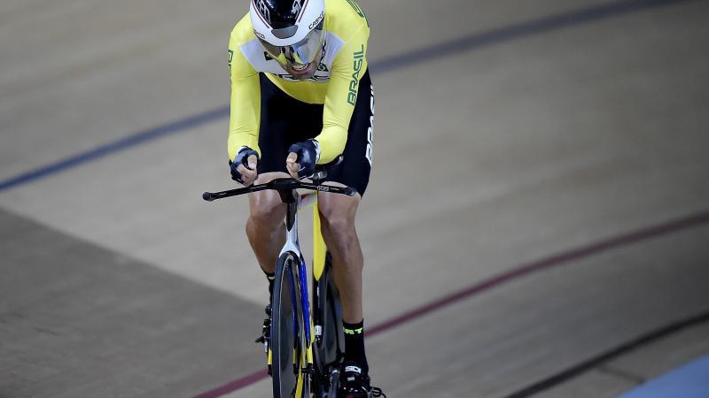 A male Para cyclist going round the track