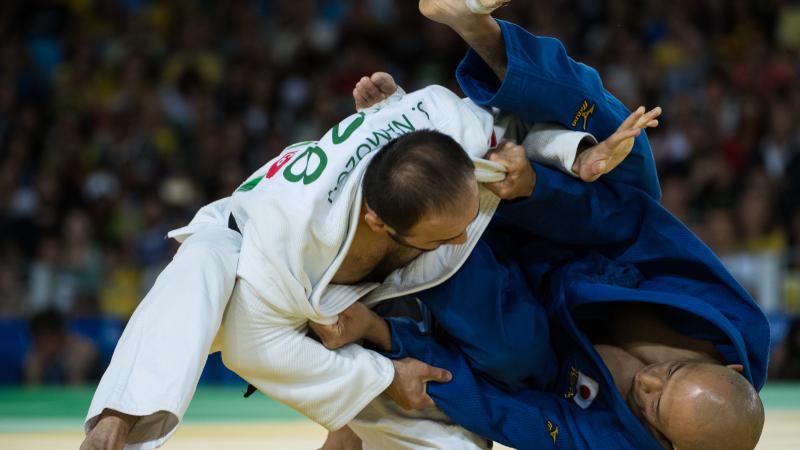 two male judokas in a fight position
