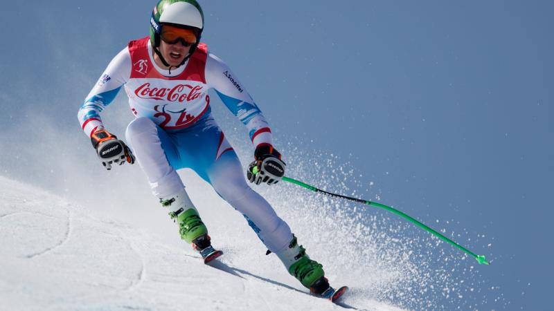 a male standing Para alpine skier in action