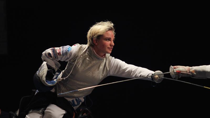 a female wheelchair fencer in action
