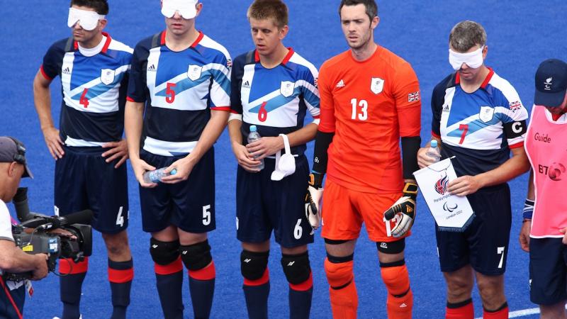 a group of blind football players line up before a match