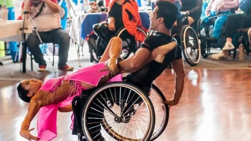 a Para dance couple in a pose on the dance floor