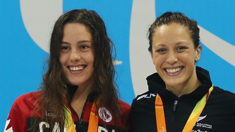 Aurelie Rivard and Sophie Pascoe two female Para swimmers smiling on the podium