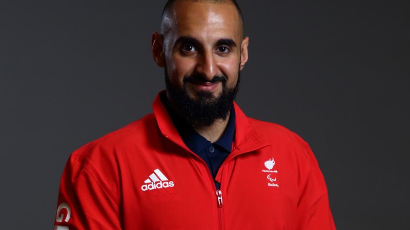 a male powerlifter smiles for the camera