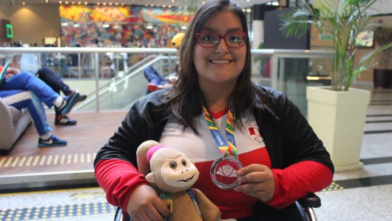 a female Para swimmer with her medal