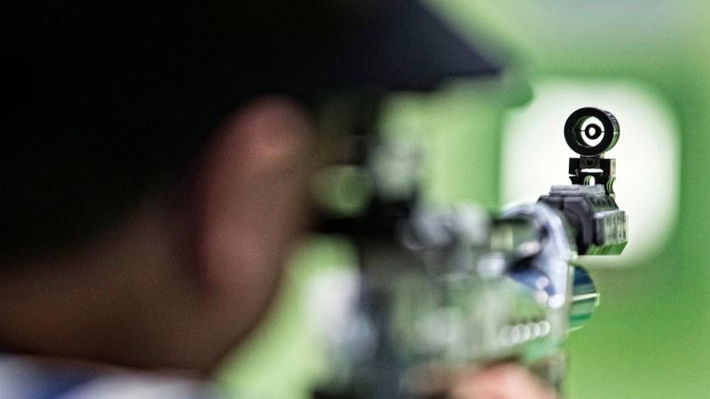 Athlete with a rifle aiming at a target