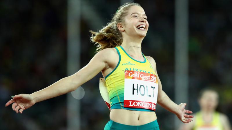 a female Para sprinter crosses the finish line