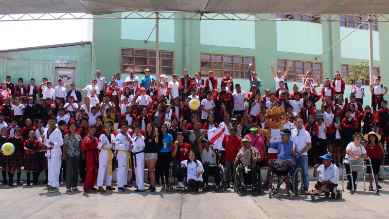 a group of Para athletes and schoolchildren