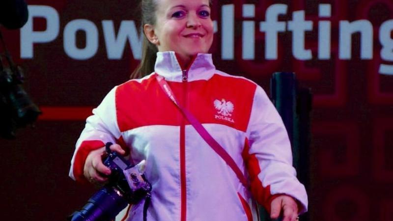 a female powerlifter with a camera