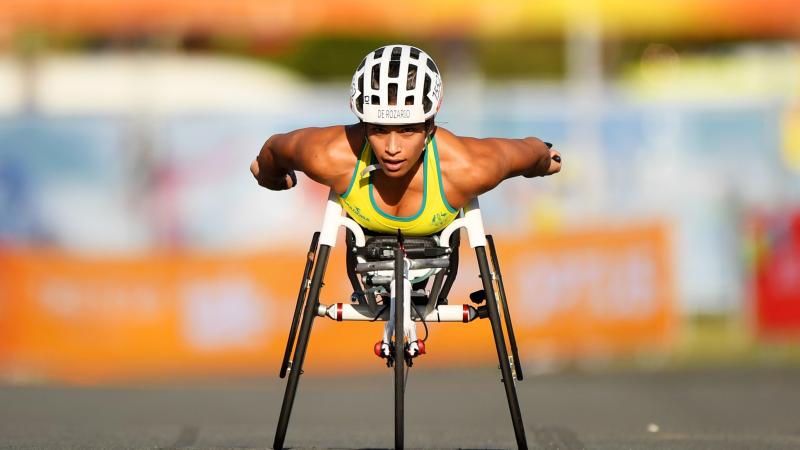 a female wheelchair racer sprints towards the line