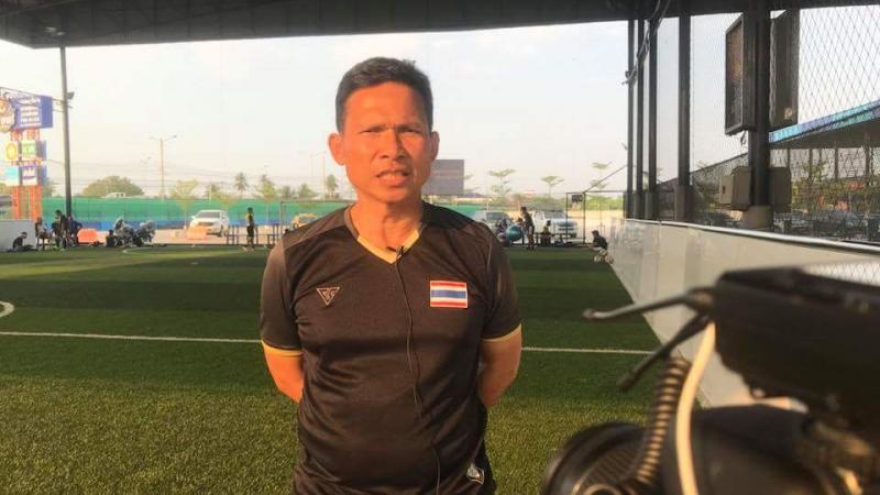 a man standing in front of a football pitch